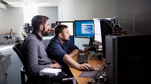 Two men looking at PC