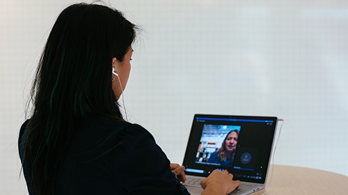 A lady typing on a laptop