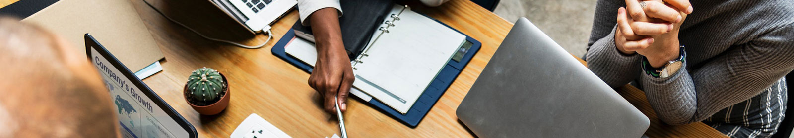 Three people are working on a table