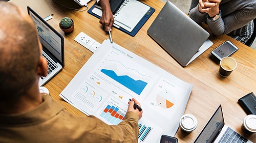 Three people are working on a table