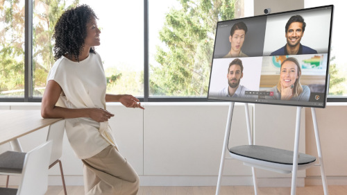 Woman attending video conferencing with team member