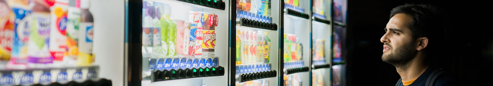 a man looking at vending machine