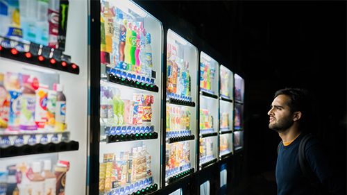 a man looking at vending machine