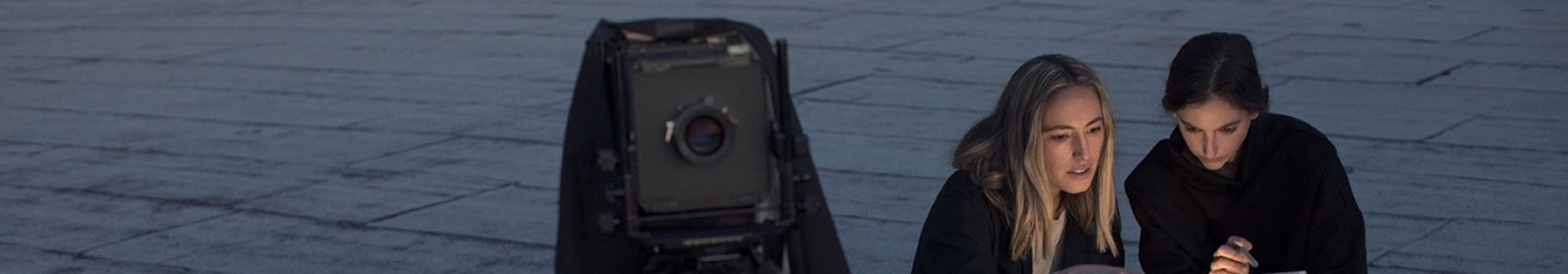 women working with camera and laptop
