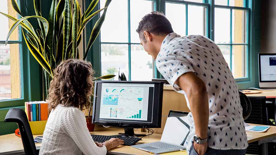 Man and woman working on a desktop