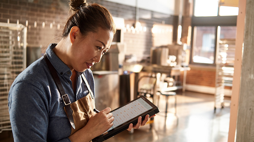 A retail employee taking an order using a tablet