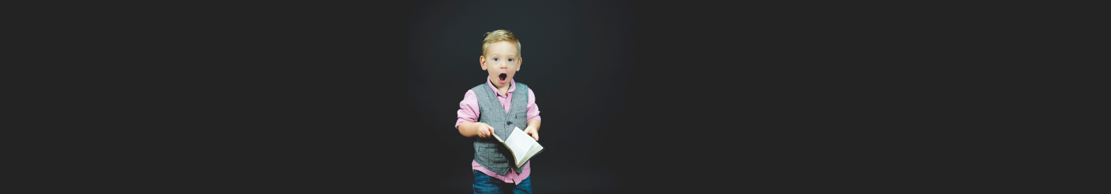 surprised child holding book