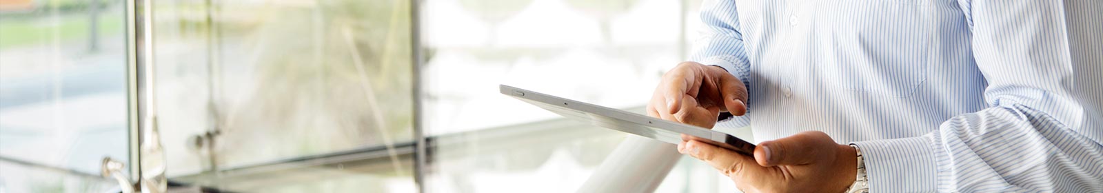 Image of a man’s hands working on a Surface tablet