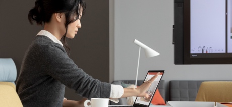 Woman touching the screen of a laptop