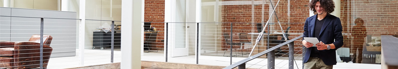 Man walking with a tablet in an office