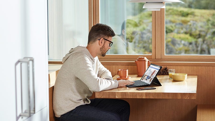 Person sitting at a table using a laptop