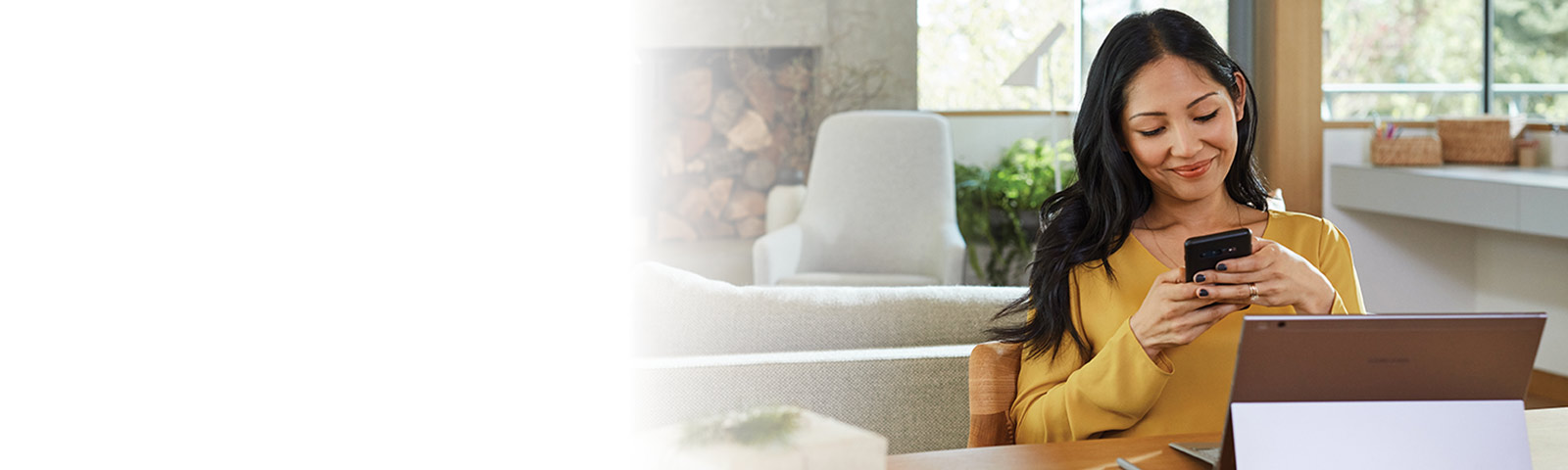 Person sitting in living room using a mobile phone
