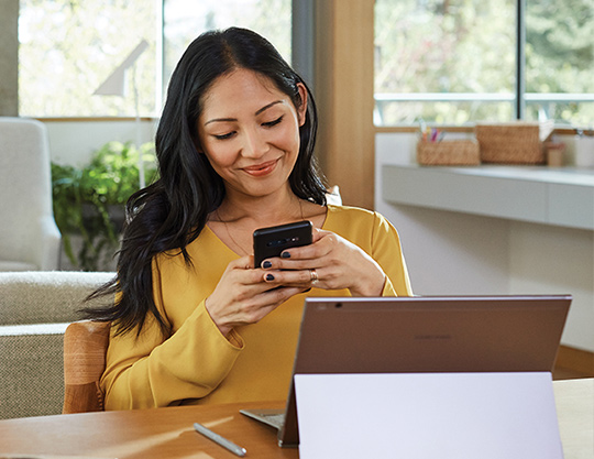Person sitting in living room using a mobile phone