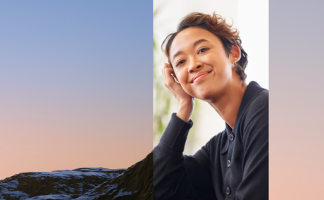 A smiling professional next to a photo of mountains