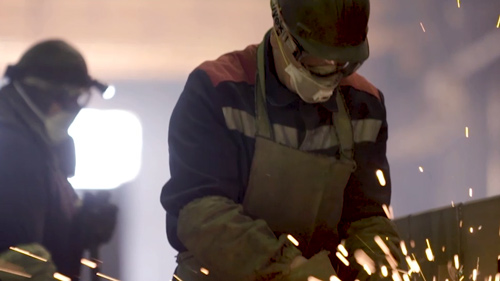 Manufacturing worker welding metal