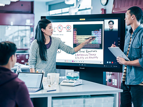 Colleagues during meeting working on Surface Hub and Surface tablets