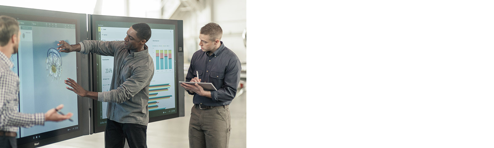 Colleagues working on two Surface Hubs