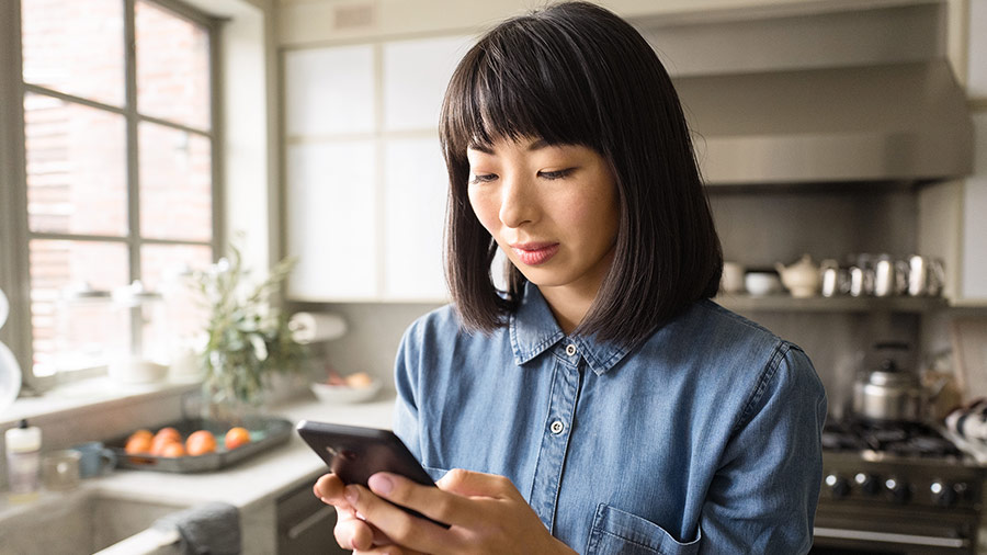 Person in kitchen using phone