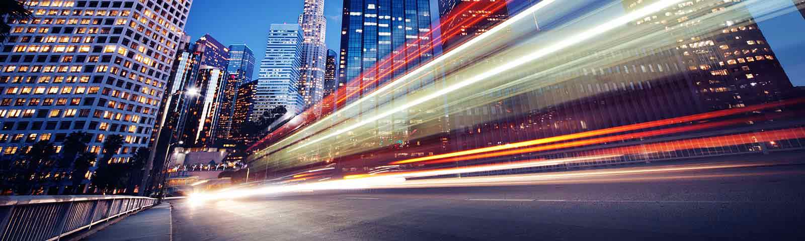 Cars drive by in a city landscape