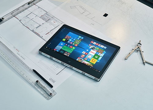 A tablet laying on a desk.
