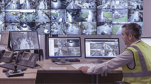 Officer monitoring security cameras