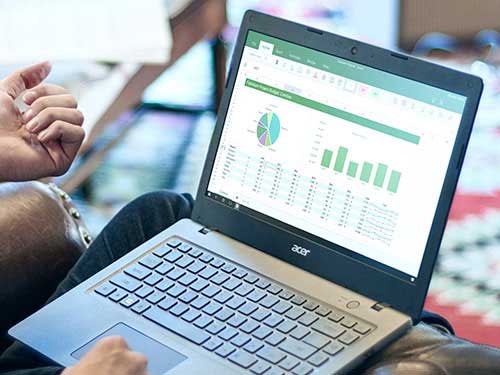 Image of hands working on a laptop