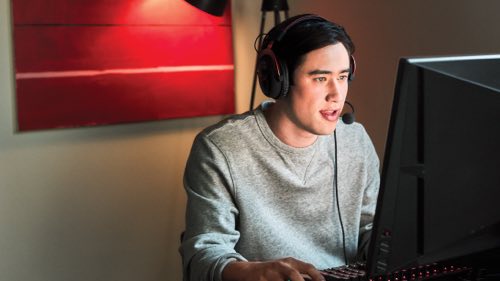 Person wearing headphones using a computer