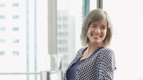 Person sitting in front of a window smiling