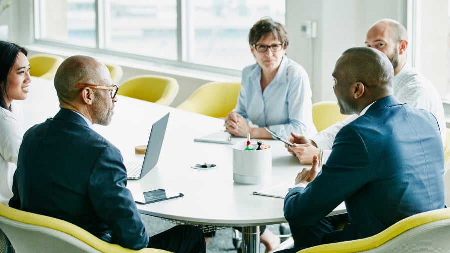 Coworkers talking around a conference table