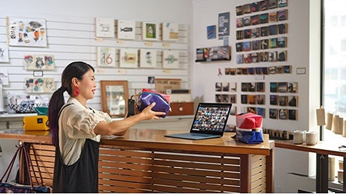Women with Surface Go at store