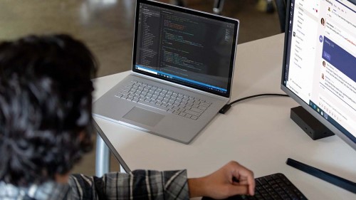 Developer coding on Surface Book 3