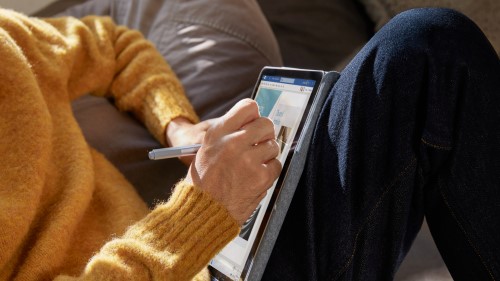 Person using tablet on couch