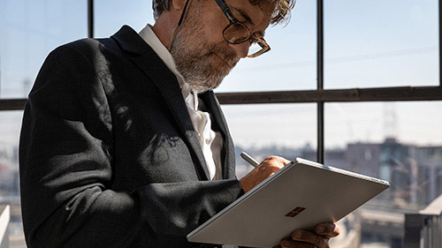 Adult male using pen on Surface Book 3