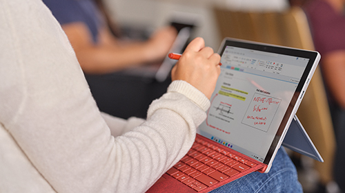 Women writing on Surface Go 2