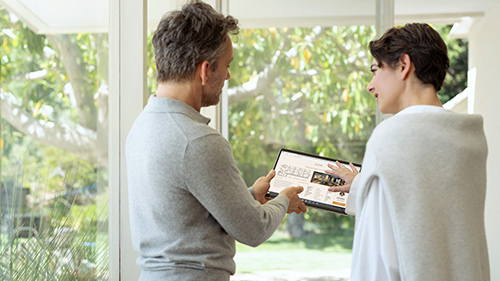 Man and women looking at Surface Pro 9