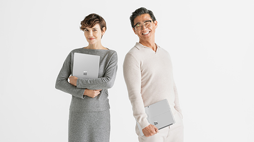 Two persons holding Surface device