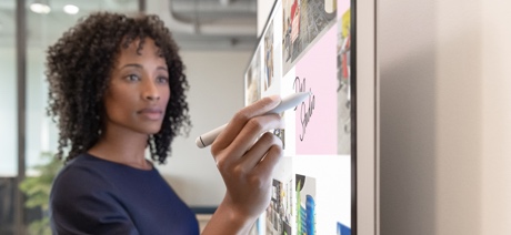 Person using Surface Hub touch screen