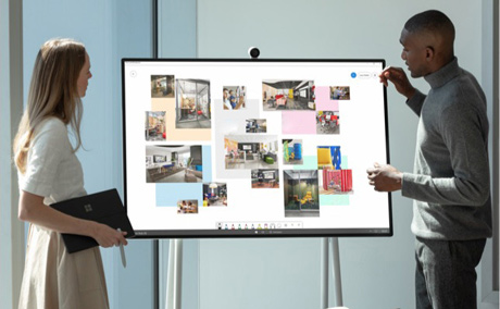 Two people meeting in front of Surface Hub