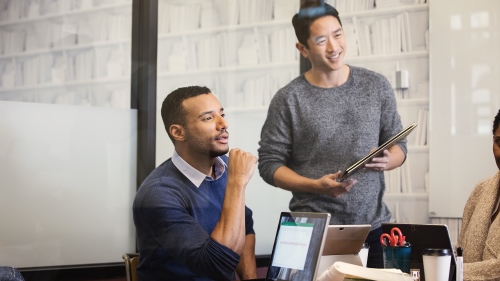 Two men look at a monitor