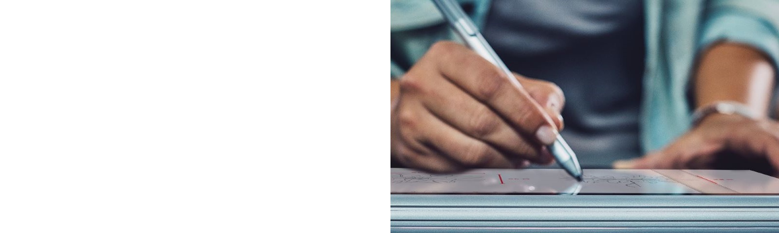 A person writes on a tablet