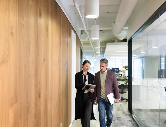 Two people in a hallway