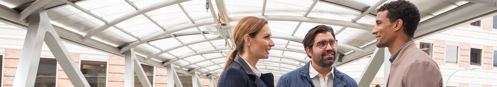 Three people discuss a Microsoft conference
