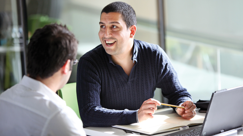 Two people working at a desk